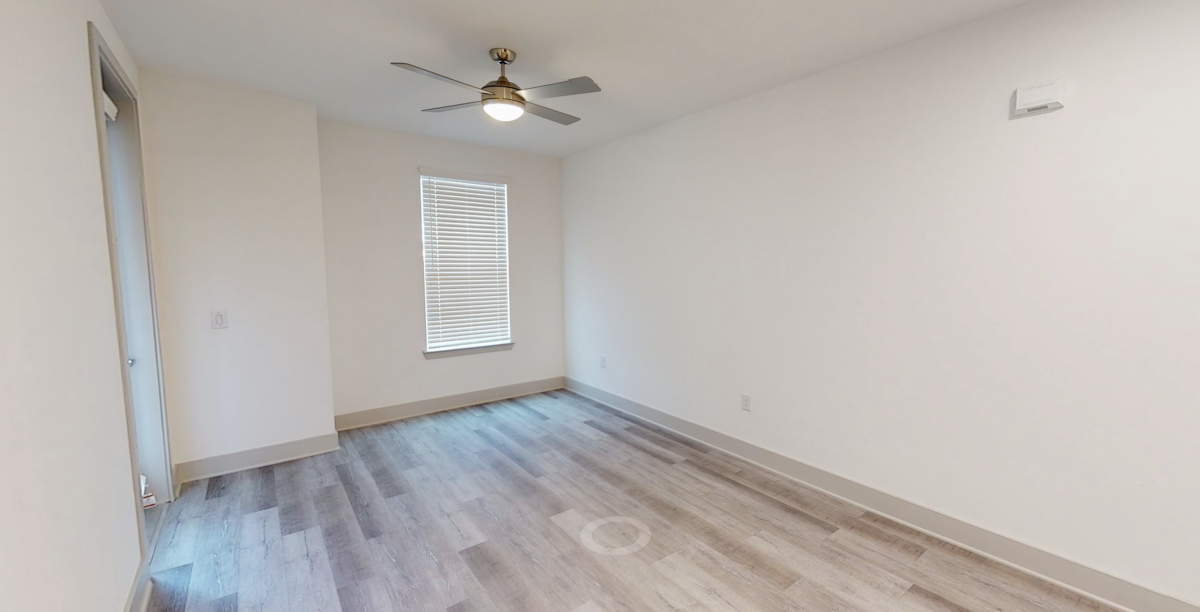 Living room with ceiling fan at our Cypress, TX apartments. Residences
