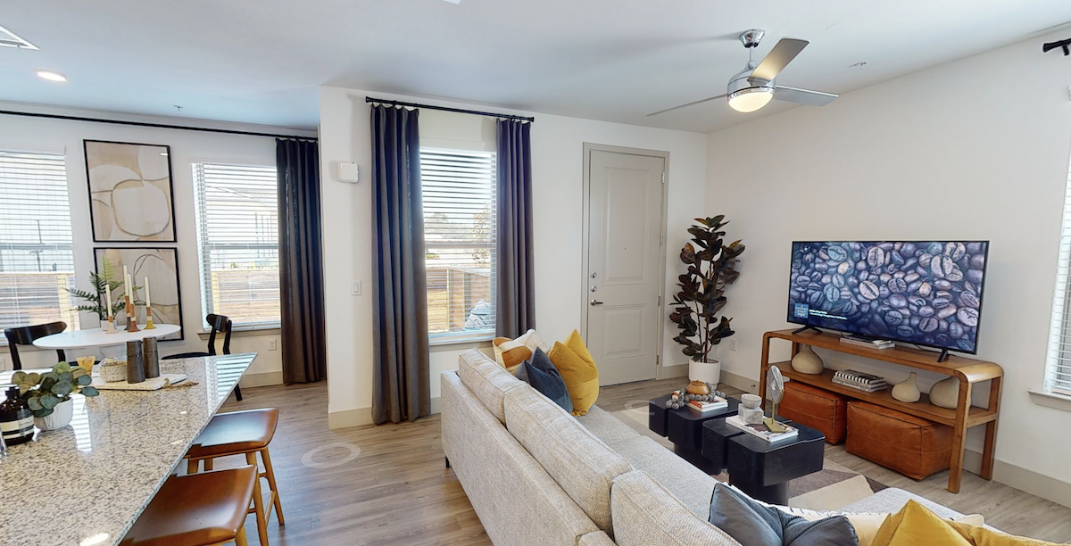 Living room with designer wood-style plank flooring at our Cypress, Texas apartments. Residences
