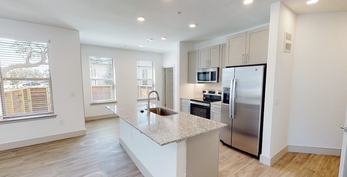 Kitchen island with granite countertops at our apartments in Cypress, TX. Residences