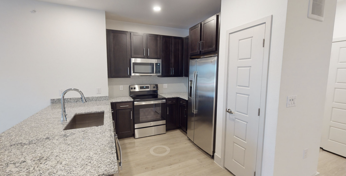 Kitchen with granite countertops at our apartments for rent in Cypress. Residences