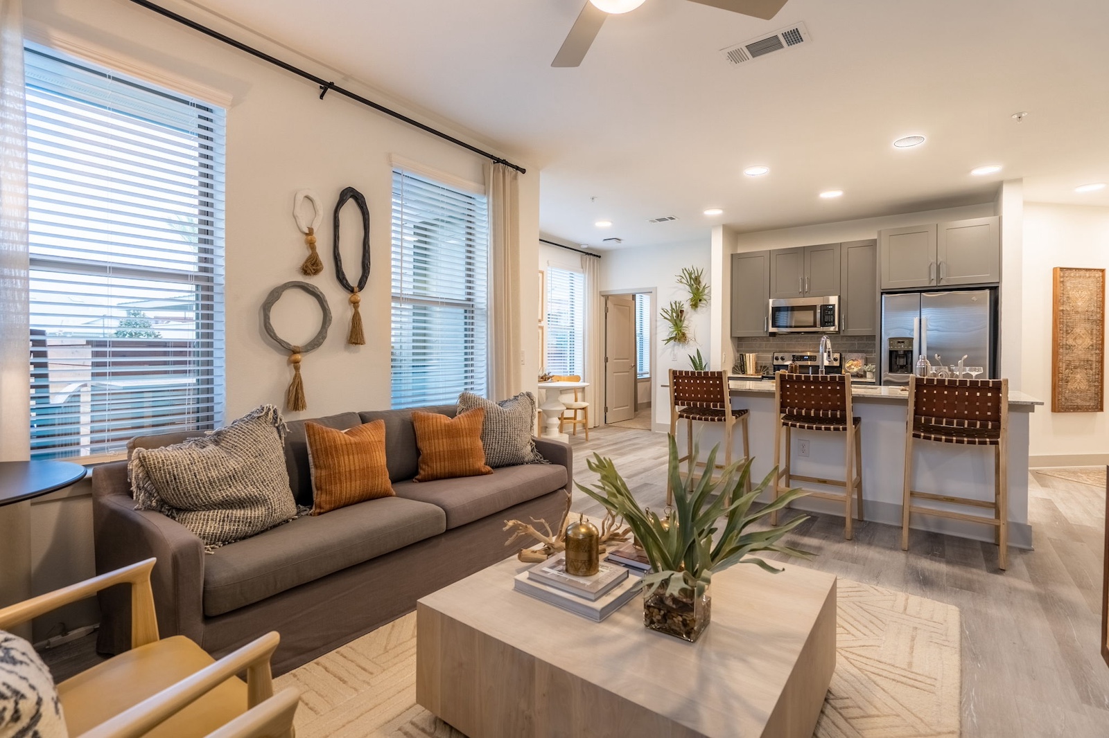 Kitchen and living room with wood-style plank flooring at our apartments near Cypress. Residences