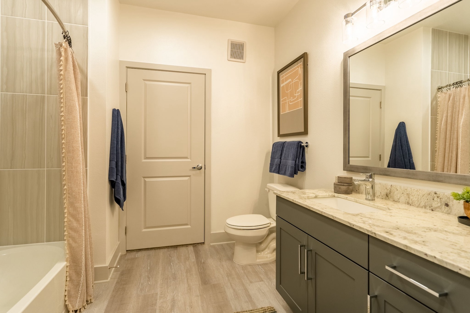 Spacious bathroom with granite countertops at our luxury apartments Cypress. Residences