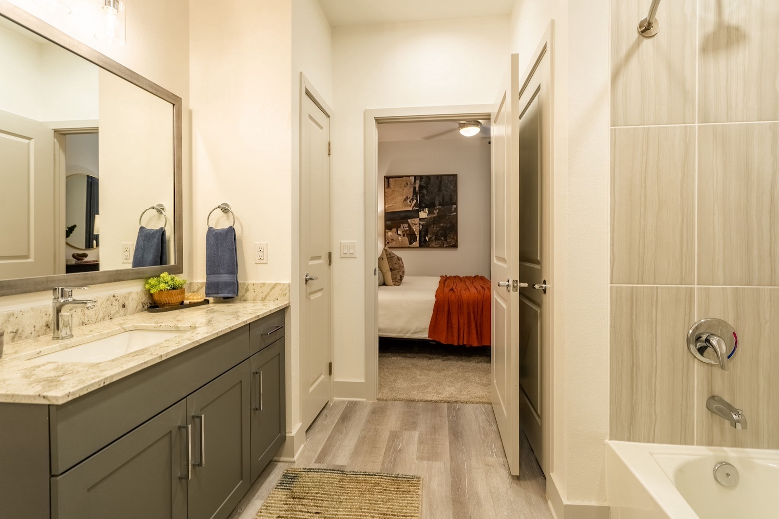 Spacious bathroom with granite countertops at our luxury apartments Cypress. Residences